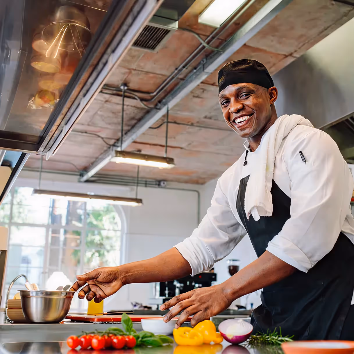 A chef prepping ingredients in a professional kitchen