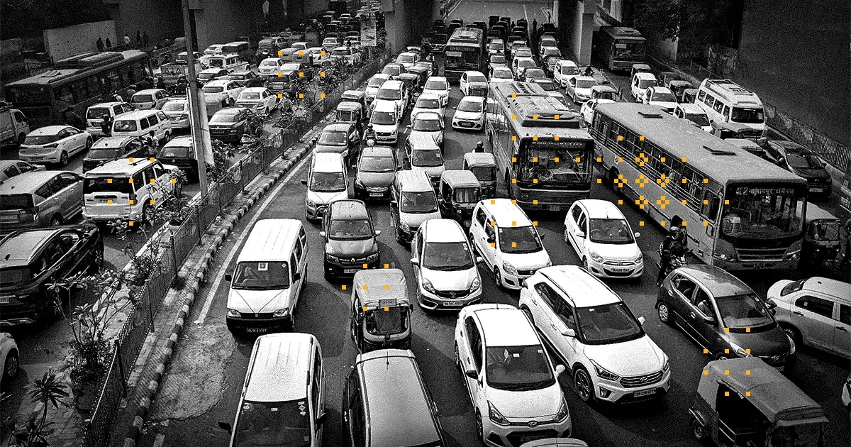 A photo of dense car traffic with decorative yellow pixel glyphs throughout the image.