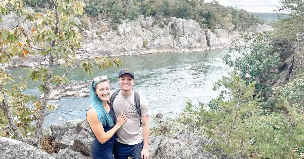 Brandon Dickerson and partner hiking next to a river