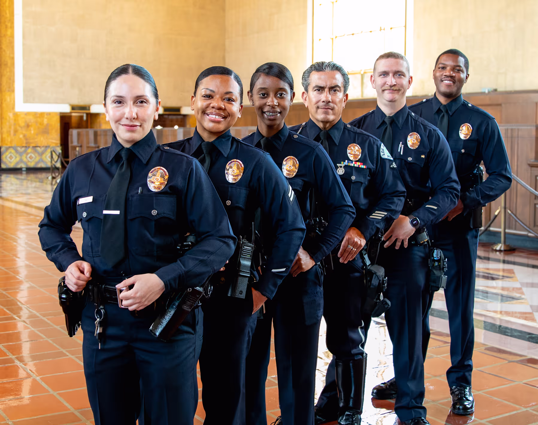 Group of diverse Officers in their Class A's, standing in a line at Union Station.