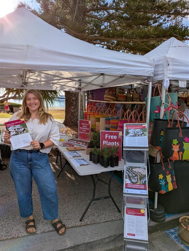 A person holding a brochure in front of a marquee