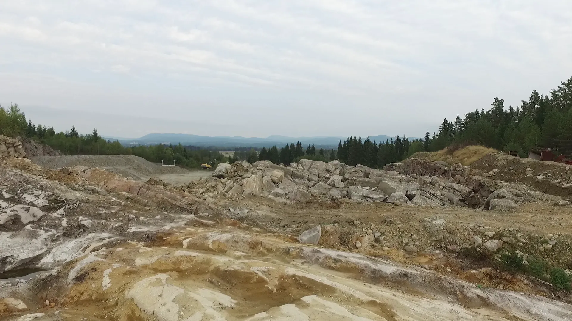 Quarry landscape with exposed rock and forest surroundings during the Misfire Clearing remote project