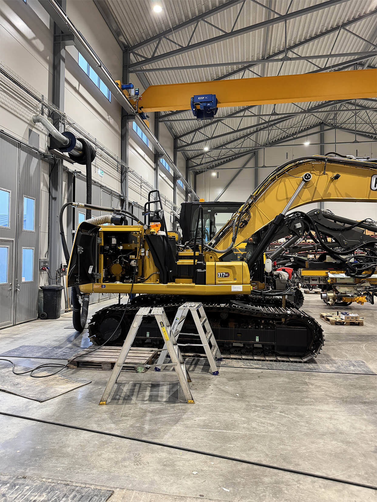ALT Text: Excavator with Scandinavian Pile Driving hydraulic equipment at a construction site

