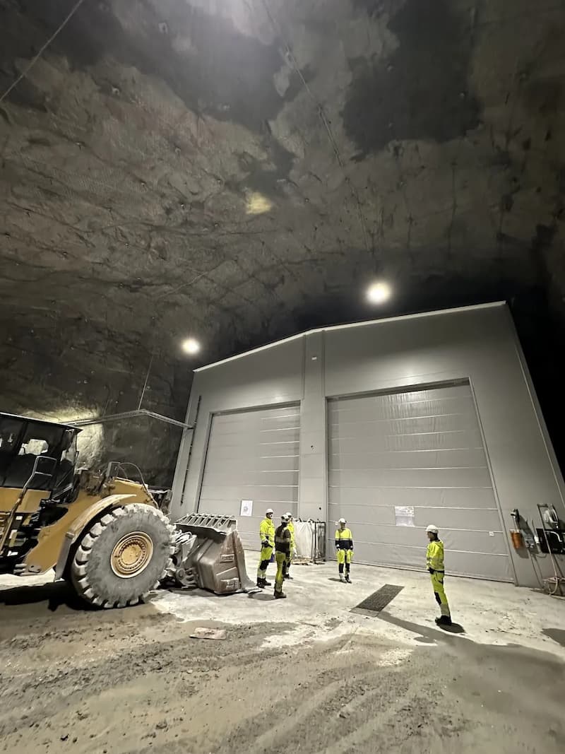 Underground facility with CAT D8 dozer and operators in high-visibility gear at Sibelco site