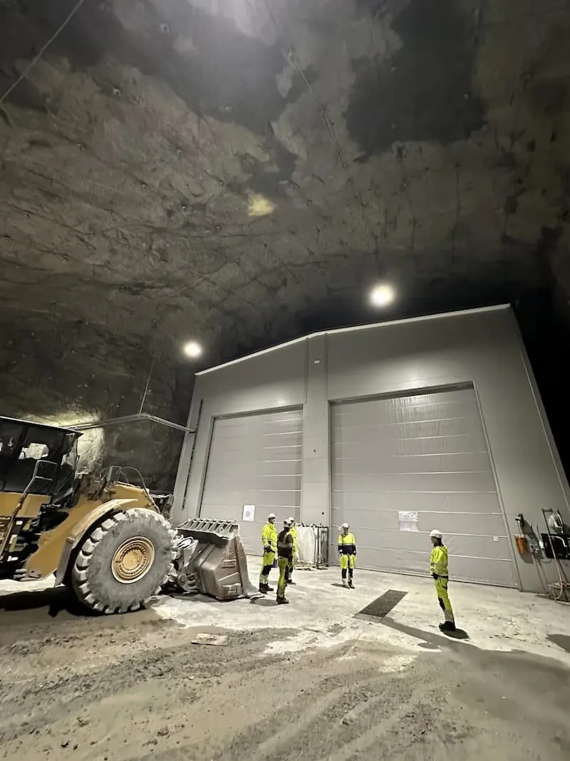Underground facility with CAT D8 dozer and operators in high-visibility gear at Sibelco site