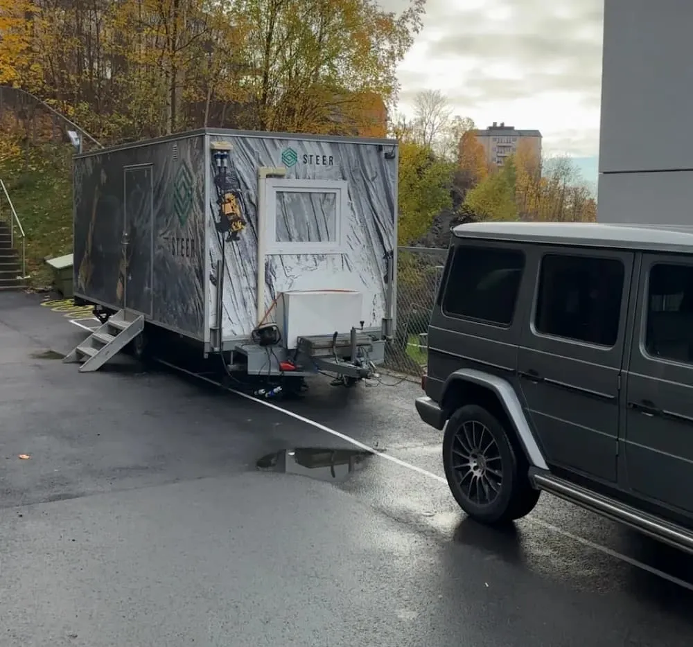 Steer mobile operations center trailer parked on-site for rapid response and remote control coordination of construction machinery.