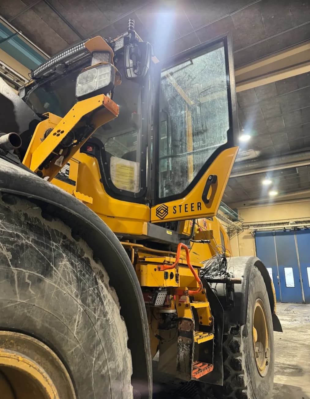Detailed view of the Volvo L90 loader integration featuring a Steer custom wiring harness and CAN gateway for remote machine data access.