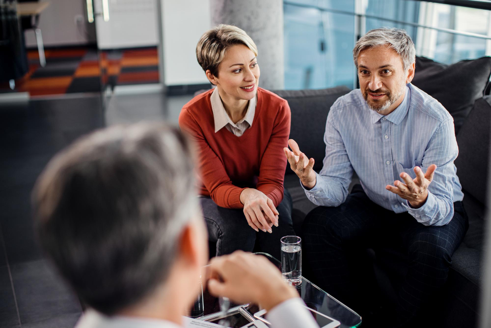 Two colleagues having a conversation in an office setting