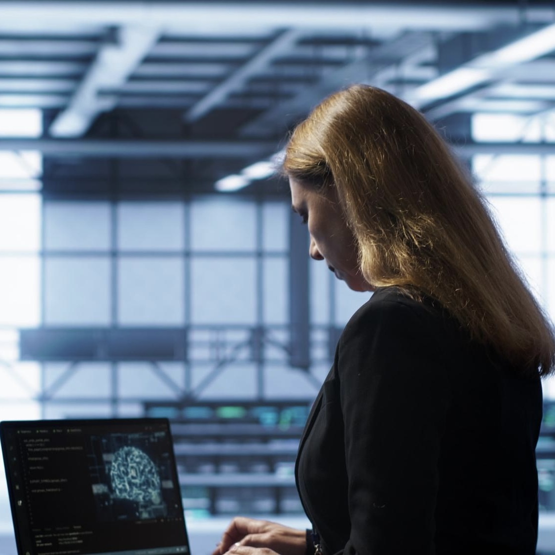 Woman using a tablet in a modern, tech-forward office environment