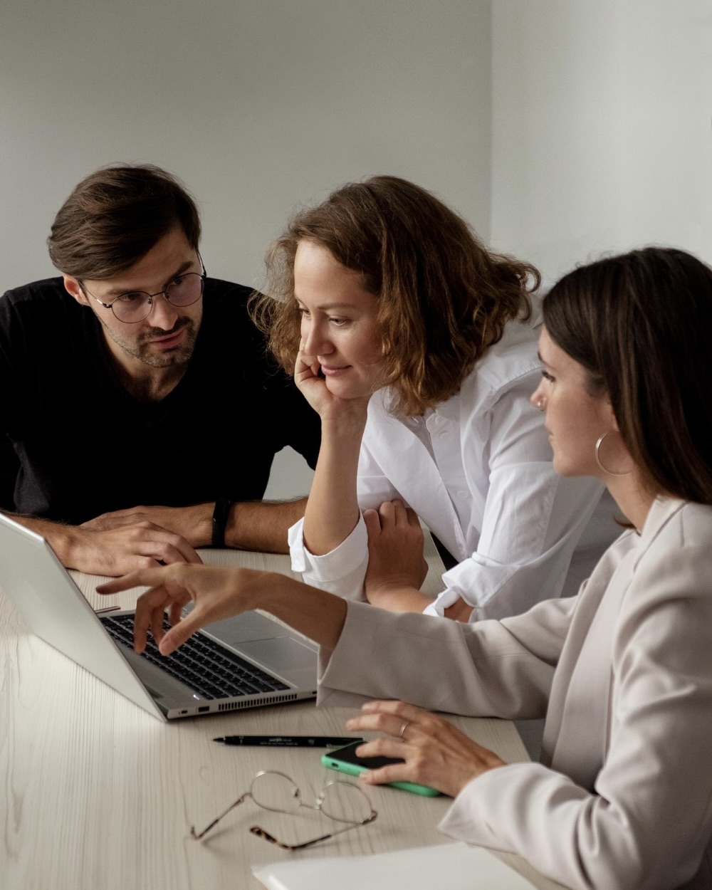 Woman and man looking down thoughtfully in an office setting