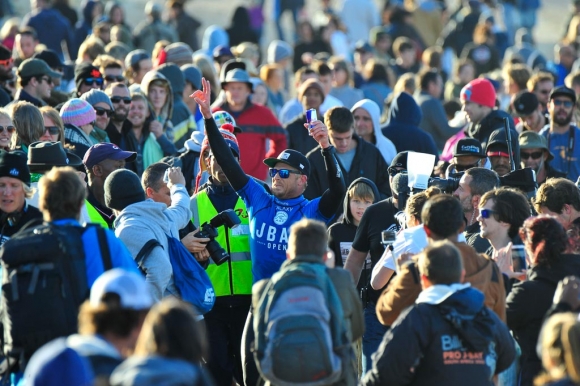Mick Fanning celebrating post win surrounded by crowds.