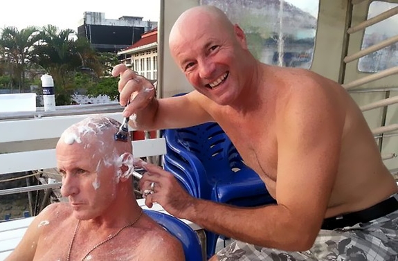 Brett Archibald shaves Anthony Singleton in Padang harbour before his ordeal. Photo JM Tostee