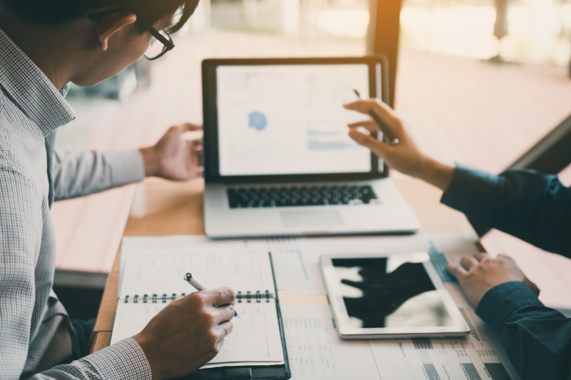 People conferring with laptop