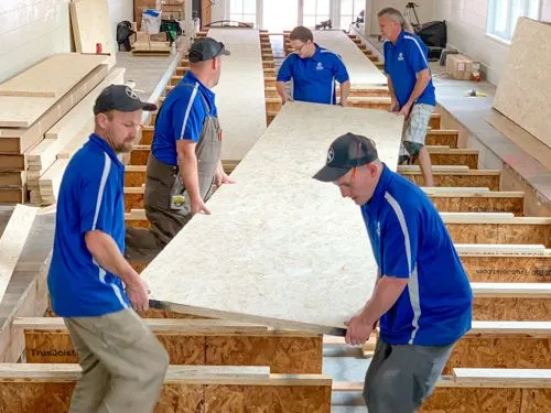 Home bowling alley installers building a bowling lane.