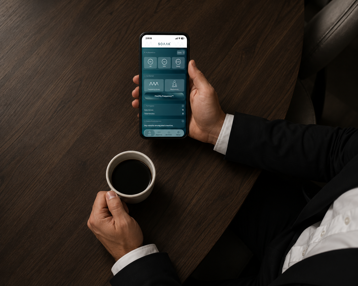 Person holding a mug while a device displays the “Sleep Well” frequency playback.