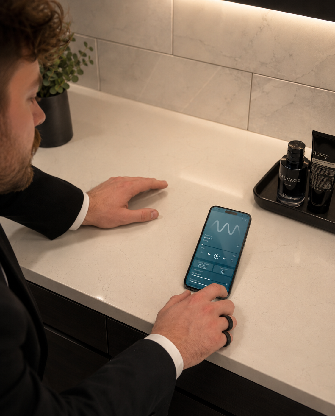 Hand pressing the play button on a device playing a sound frequency track.