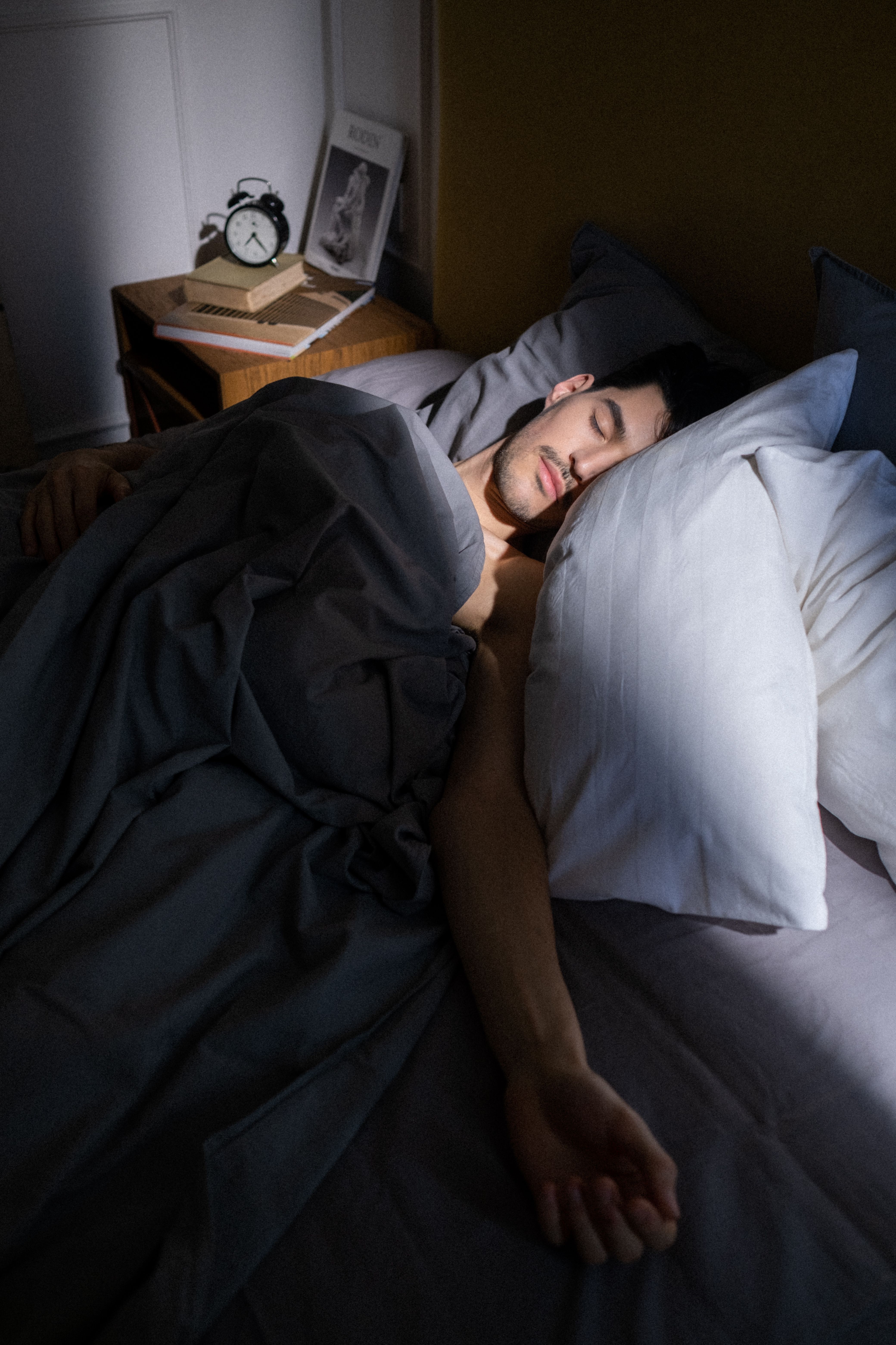 Person holding a mug while a device displays the “Sleep Well” frequency playback.