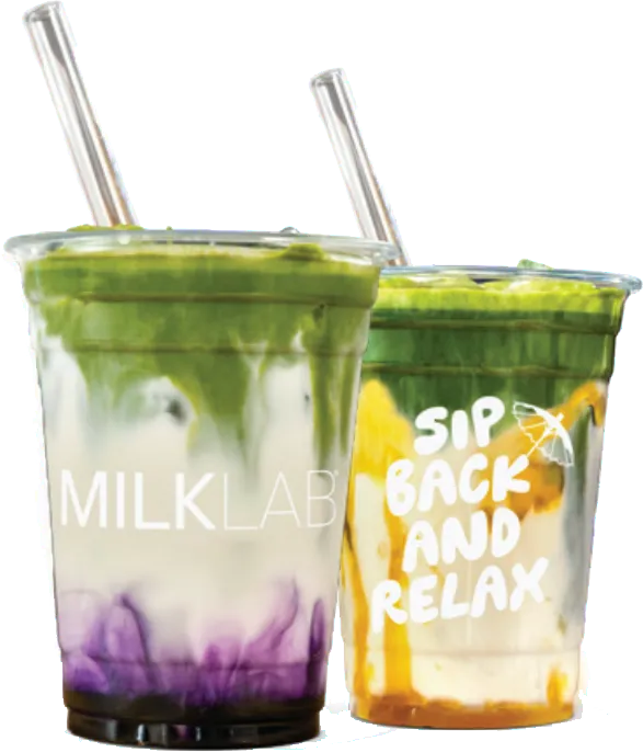 Two plastic cups with clear lids and straws containing layered matcha drinks with milk and colorful swirls; one cup has MILKLAB branding, the other says SIP BACK AND RELAX.