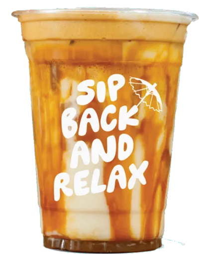 Iced coffee drink with cream swirls in a clear plastic cup labeled 'Sip Back and Relax' with a small umbrella graphic.