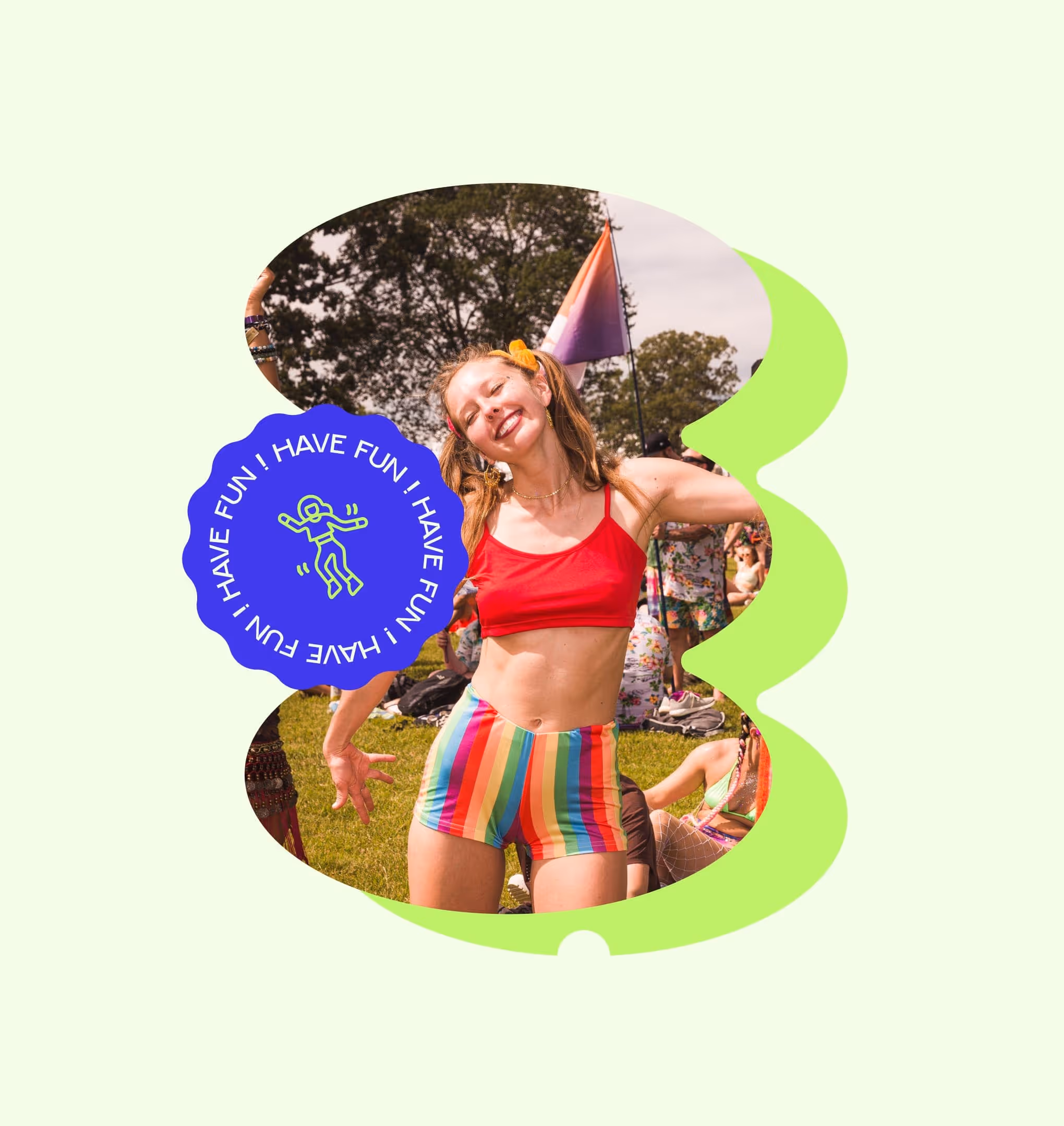 Jeune femme souriante en débardeur rouge et short arc-en-ciel dans un parc lors d'un festival.
