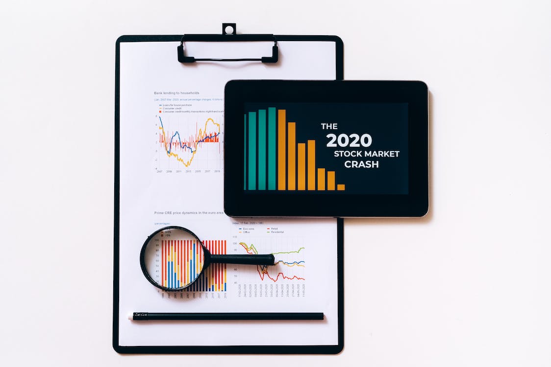 Free Clipboard with Statistical Data and Digital Tablet with Stock Market Display on Screen Stock Photo