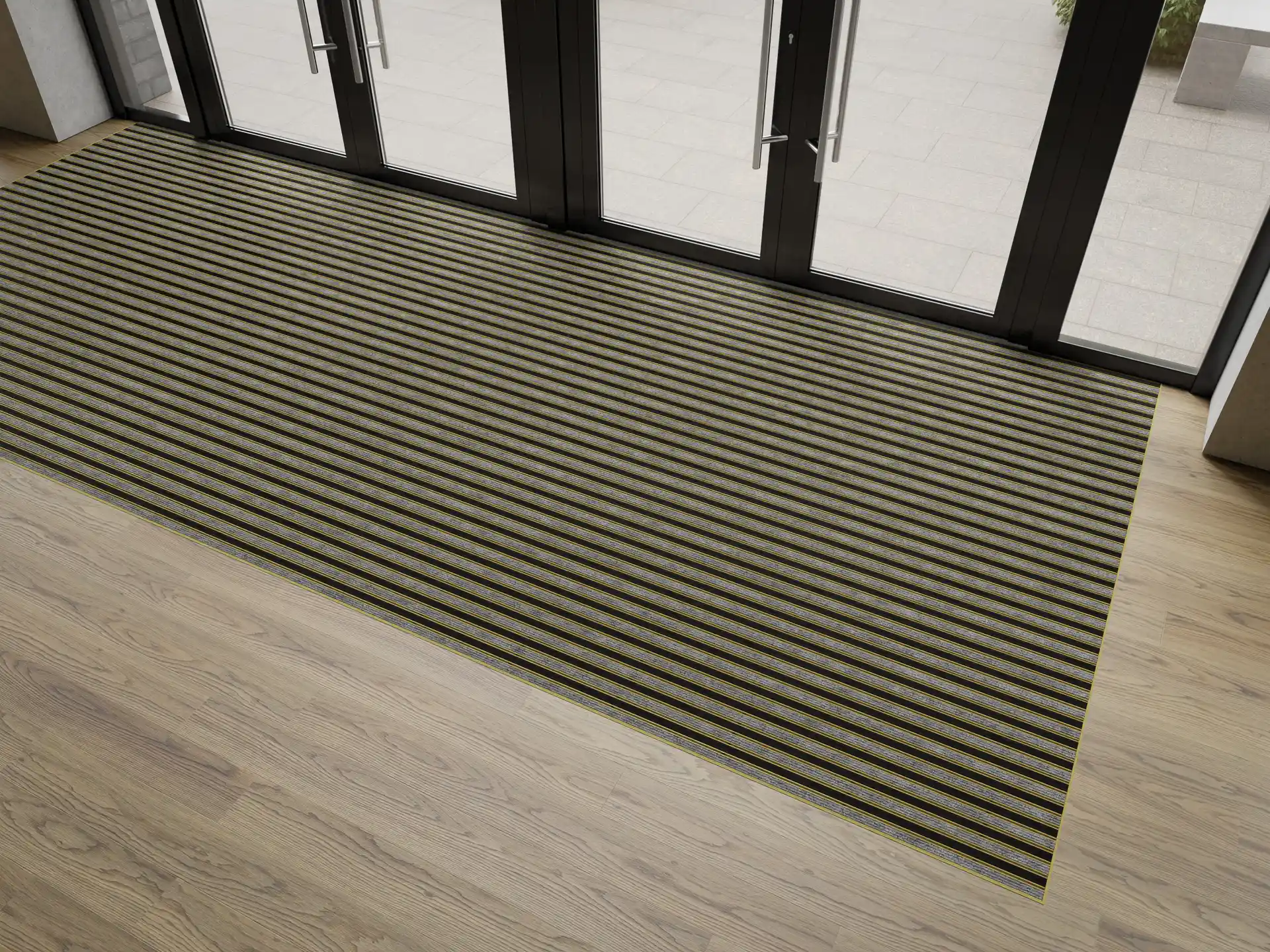 Indoor Milieu einer goldfarbenen Aluprofil Fußmatte und der Einlage Rips im Eingangsbereich