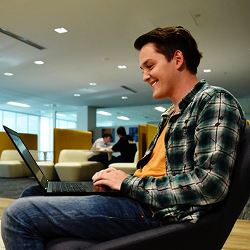 a photo of James Fletcher on his laptop