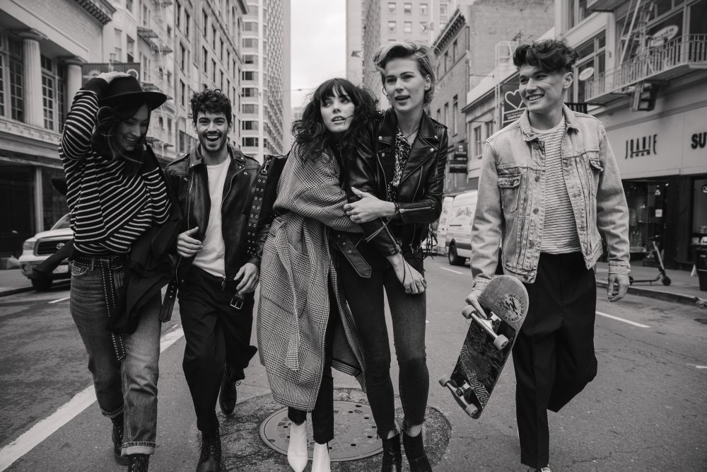 5 people walking down the street in san francisco
