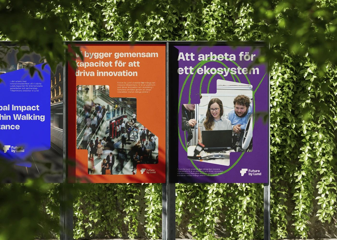 Future by Lund brand posters on a metal stand surrounded by lush greenery.