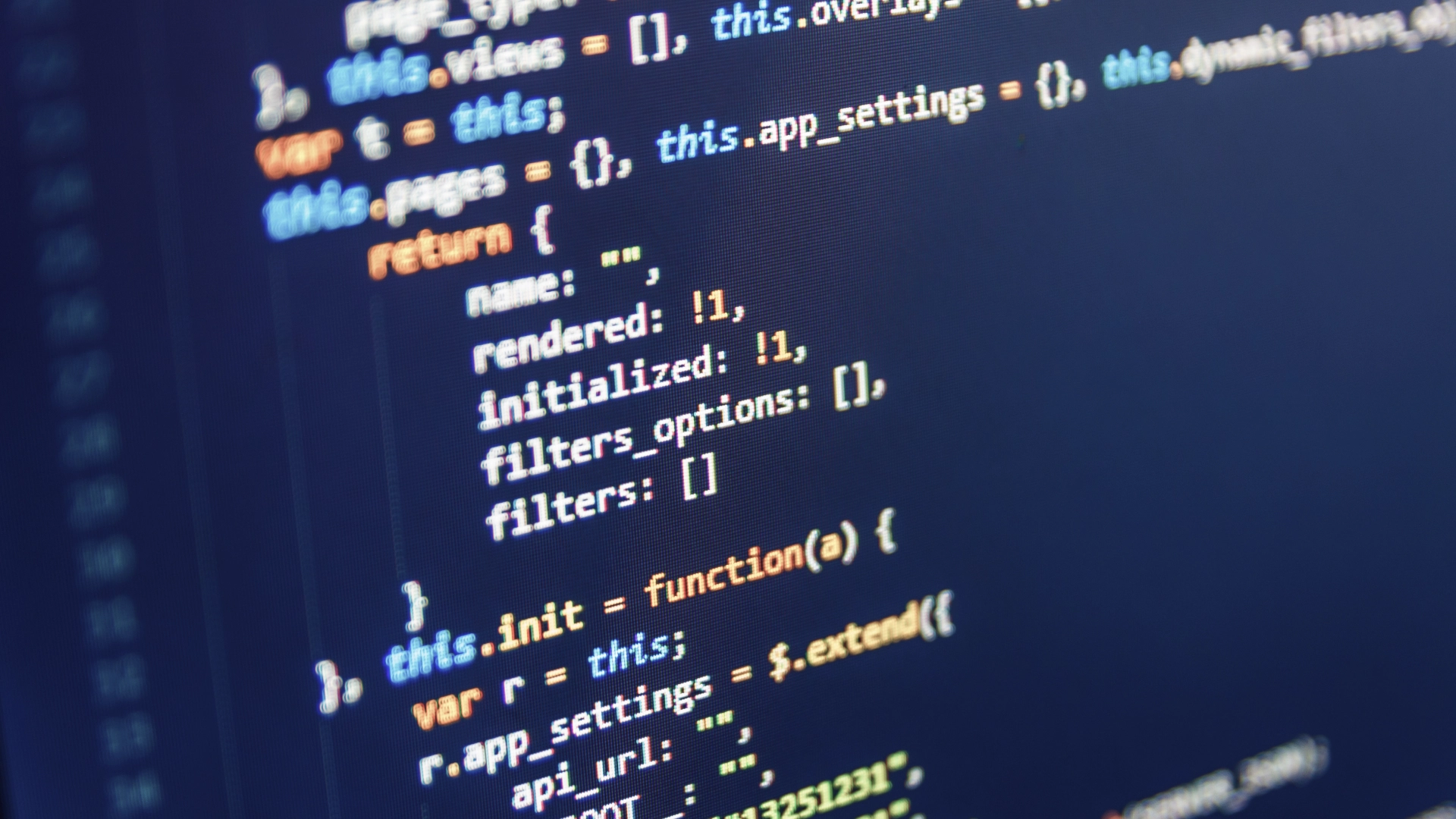 Code script on a computer screen with lines of code in various colours against a dark background.