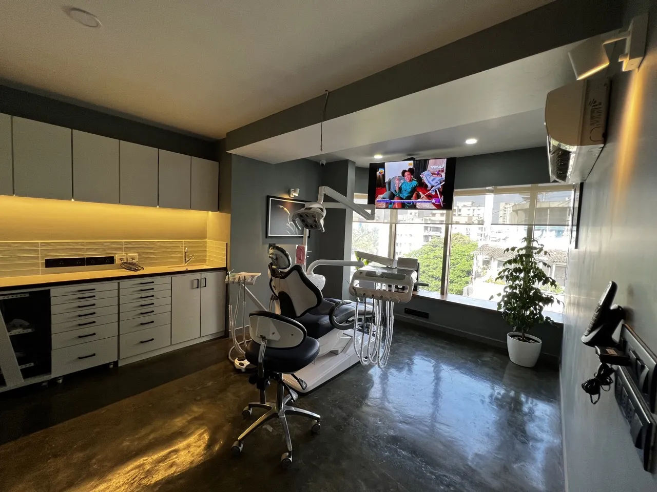Bandra West dental chair beside cabinets with warm under-shelf lighting