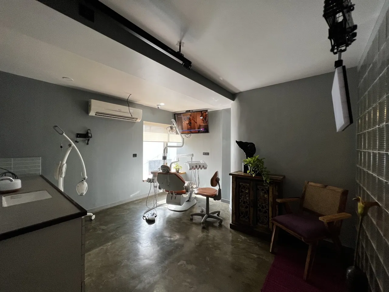 Bandra West treatment room with a dental chair and an armchair