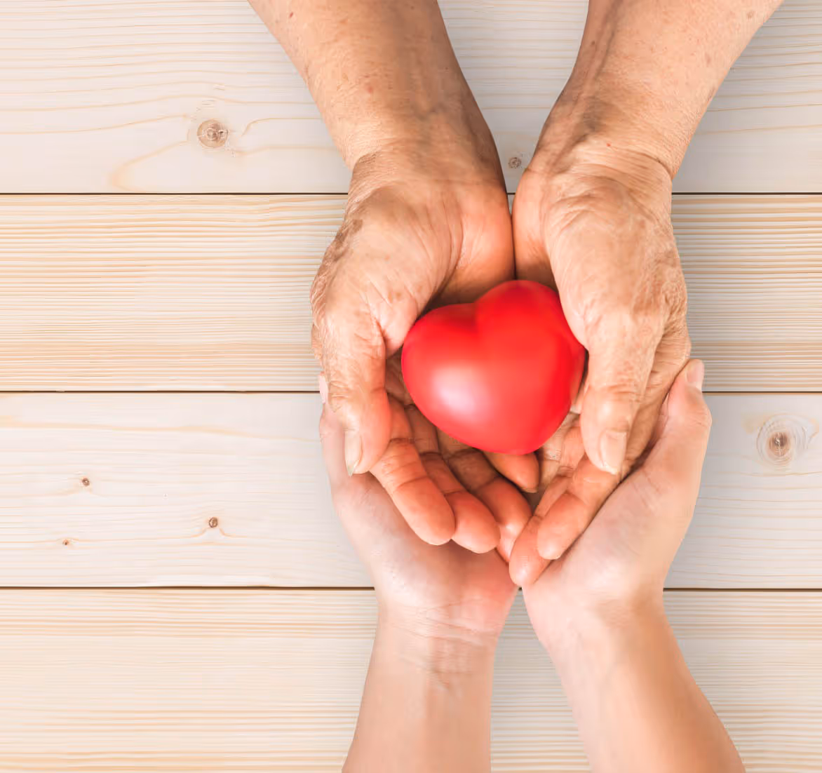 Hands holding a figurative heart.