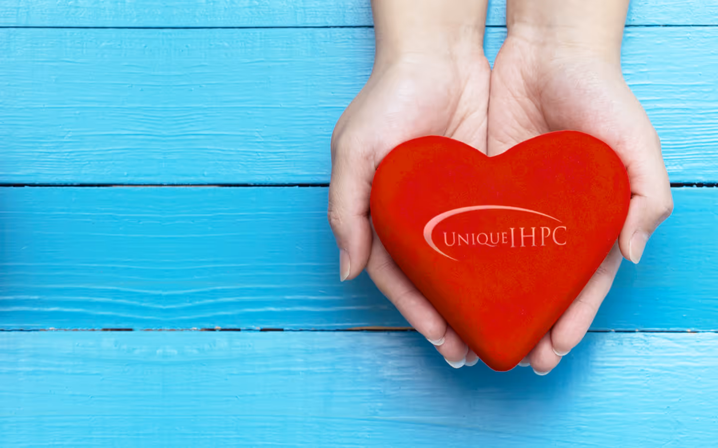 Hands holding a heart.