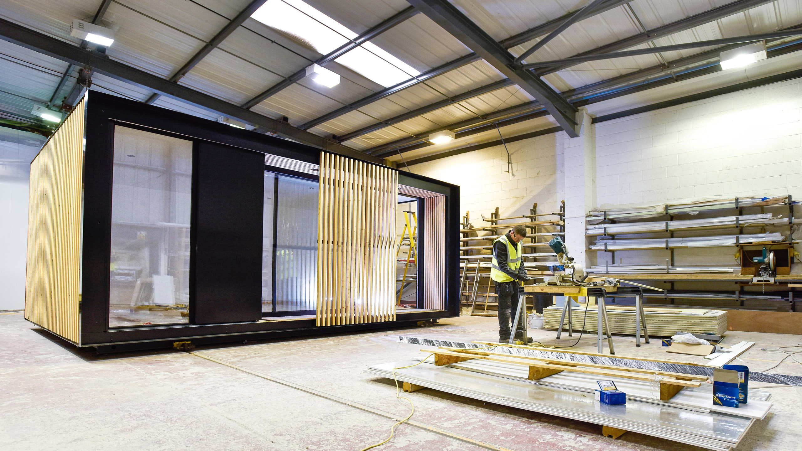 Modular garden room construction showing structural framework in factory.