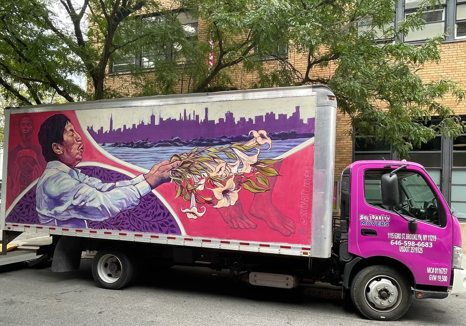 Professional movers loading furniture into moving truck in NYC
