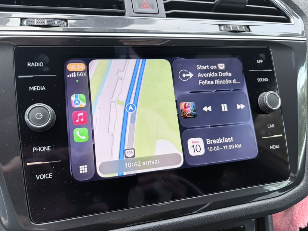 Volkswagen CarPlay dashboard showing Maps navigation, media controls, and calendar