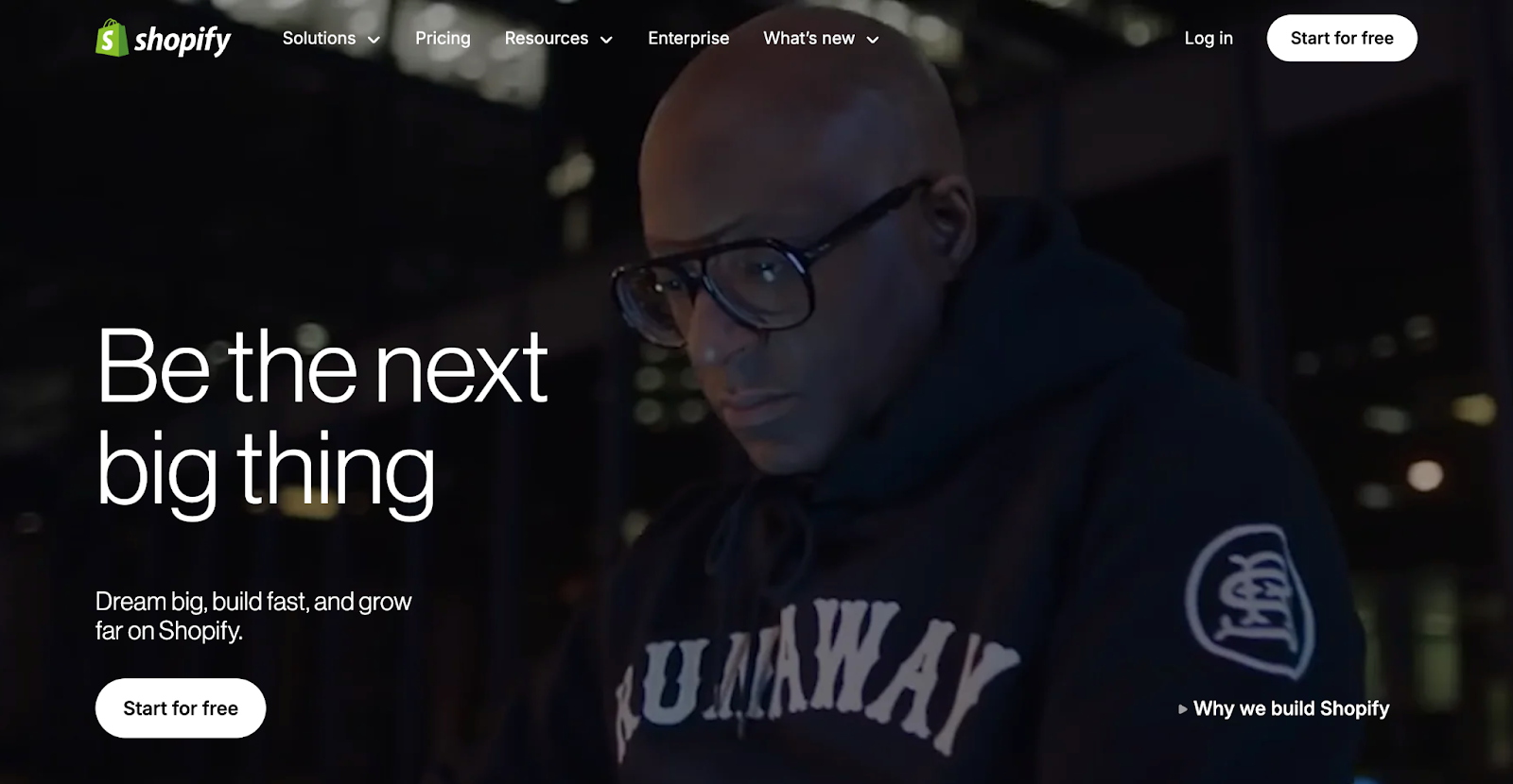 Shopify homepage featuring 'Be the next big thing' hero message with developer in branded hoodie, showcasing Shopify's e-commerce platform branding