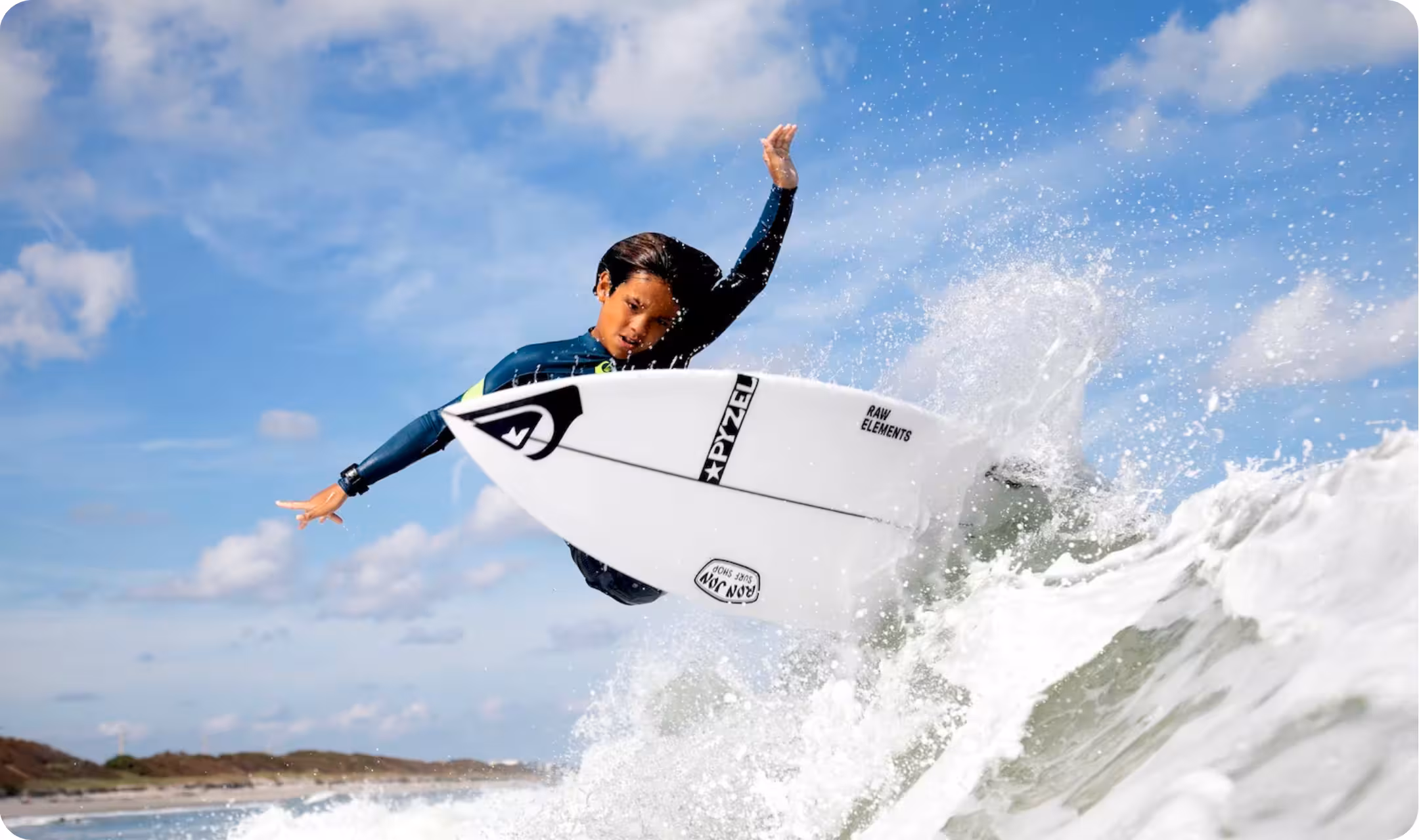 A grom surfer doing a big cutback