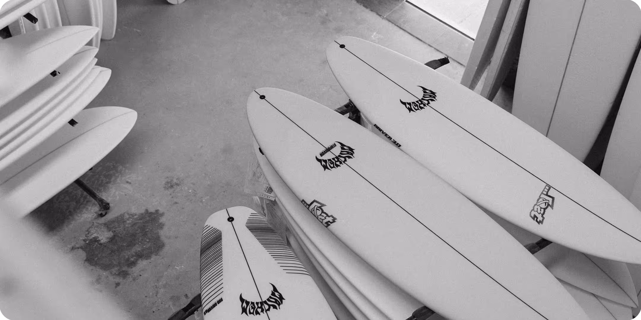 Black and white of Lost Surfboards in a board room