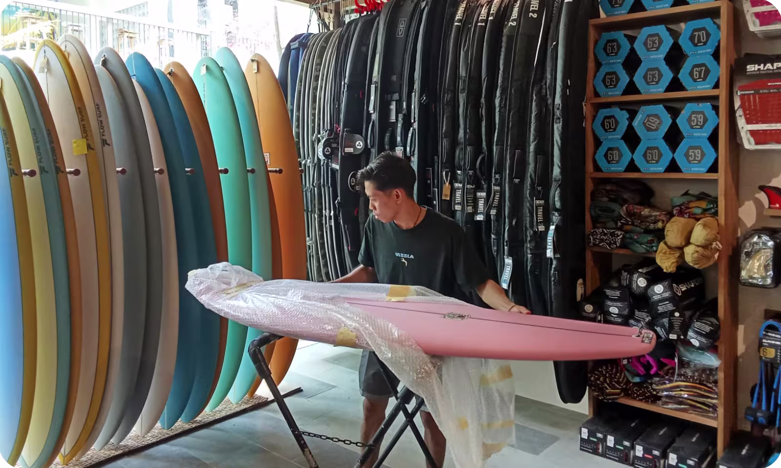 Staff packing a surfboard at Flow Surf Lombok