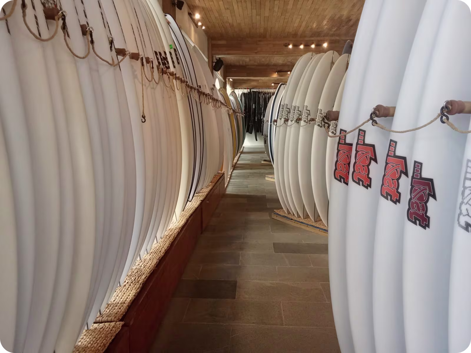 A long view down an isle of surfboards at Flow Surf Lombok