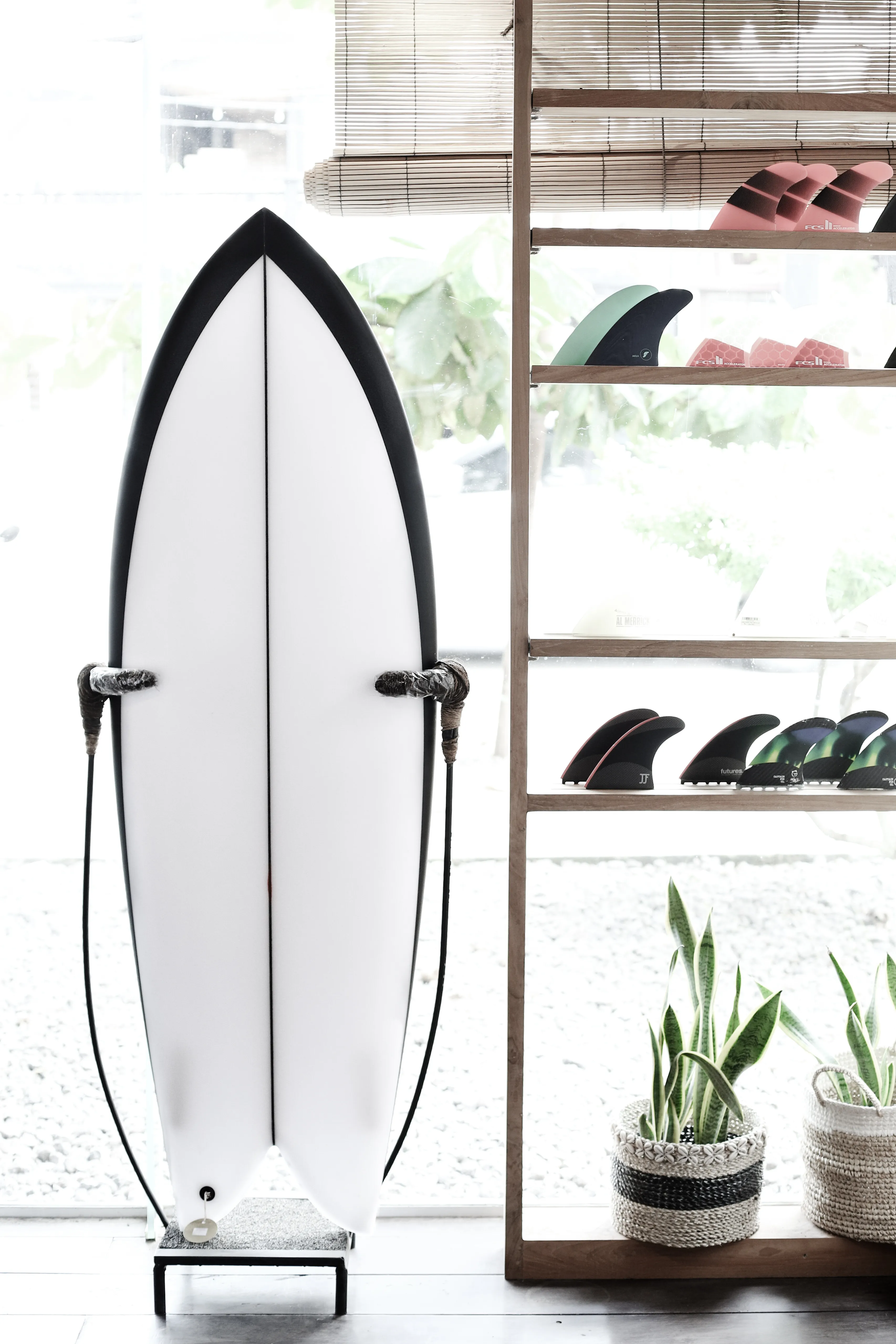 A surfboard in the window of Flow Surf Shop Lombok 