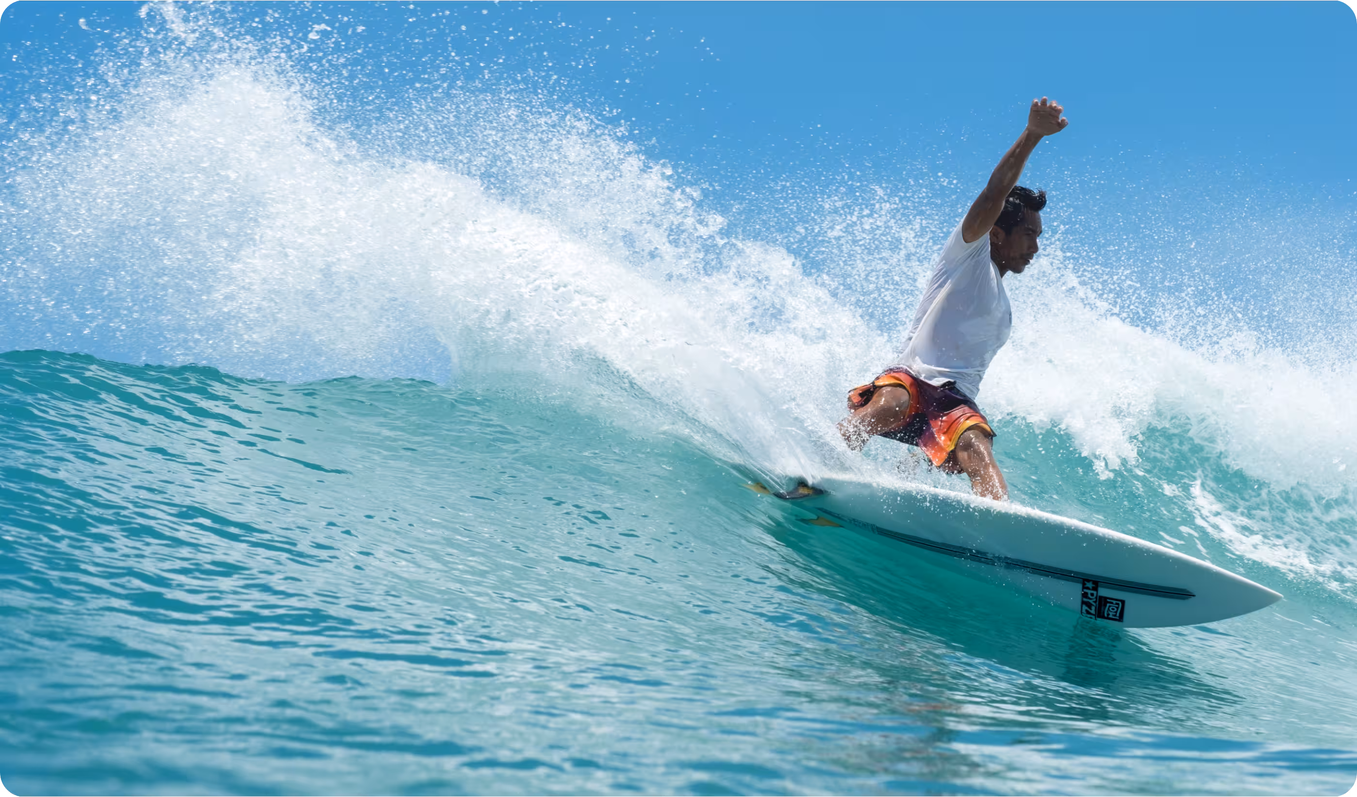 A photo of Moh Rifai surfing in very blue water