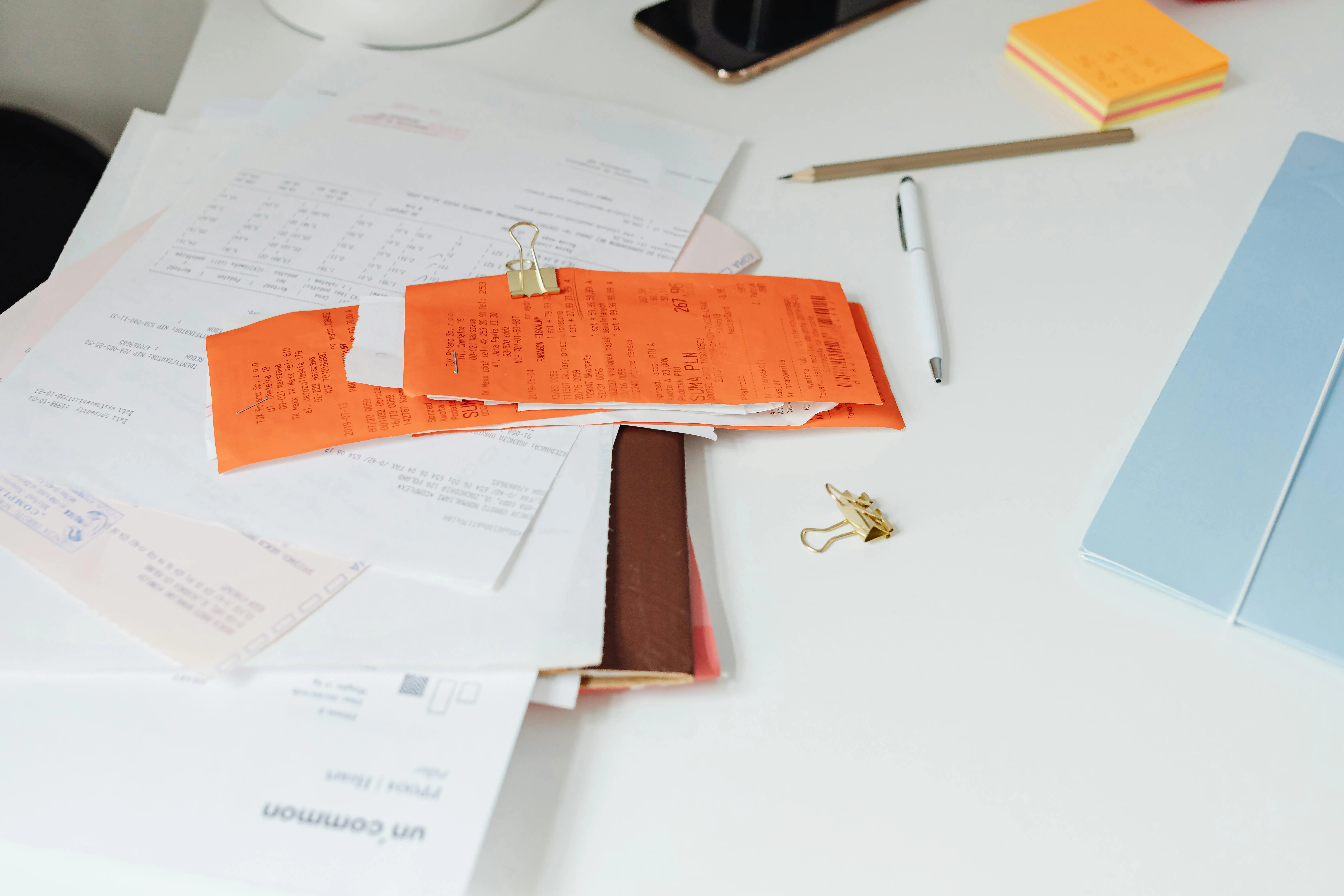receipts and financial papers on a desk