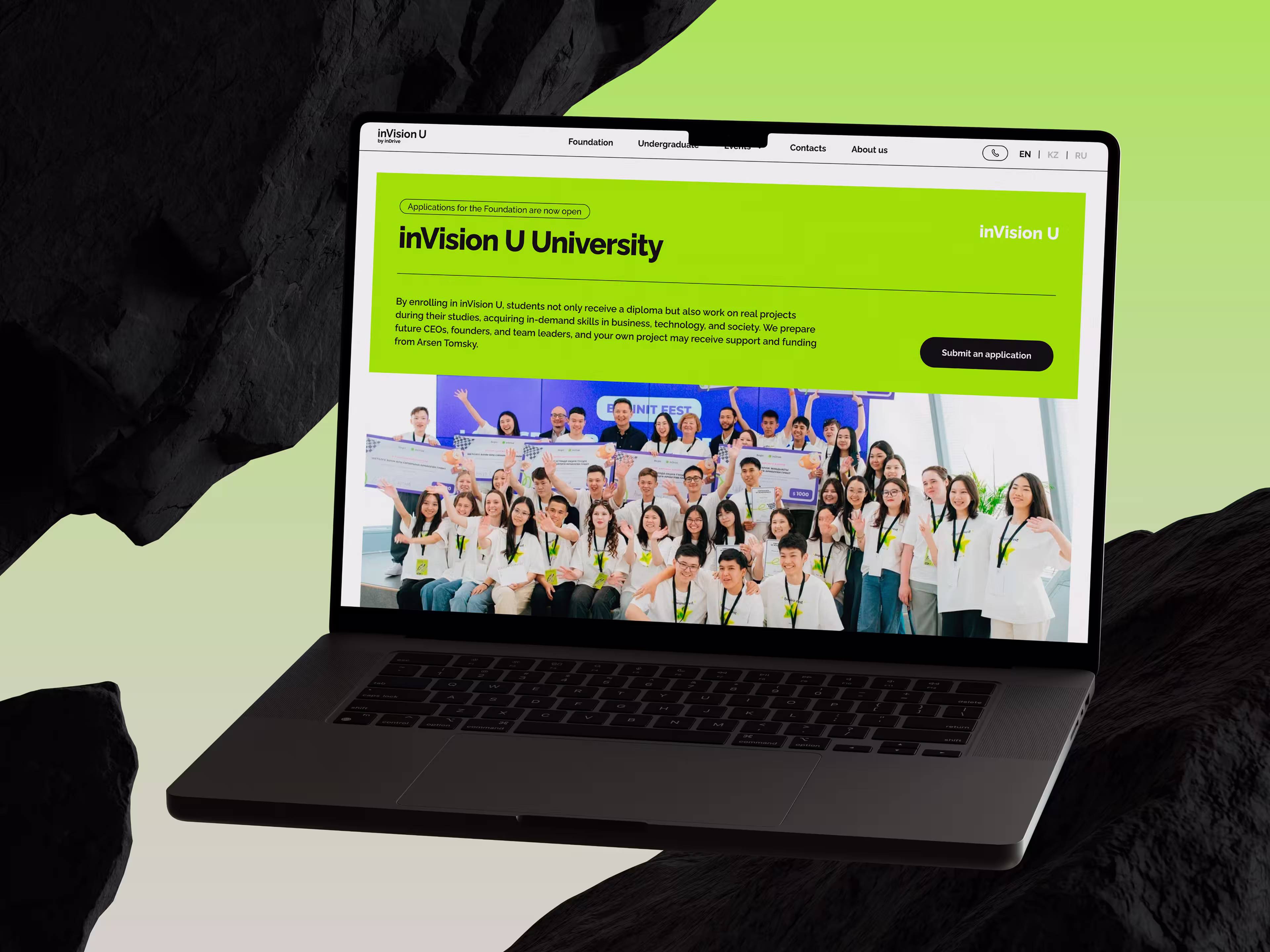 Laptop displays the green “inVision U University” website with a large diverse group photo, conveying an inclusive, welcoming educational tone.