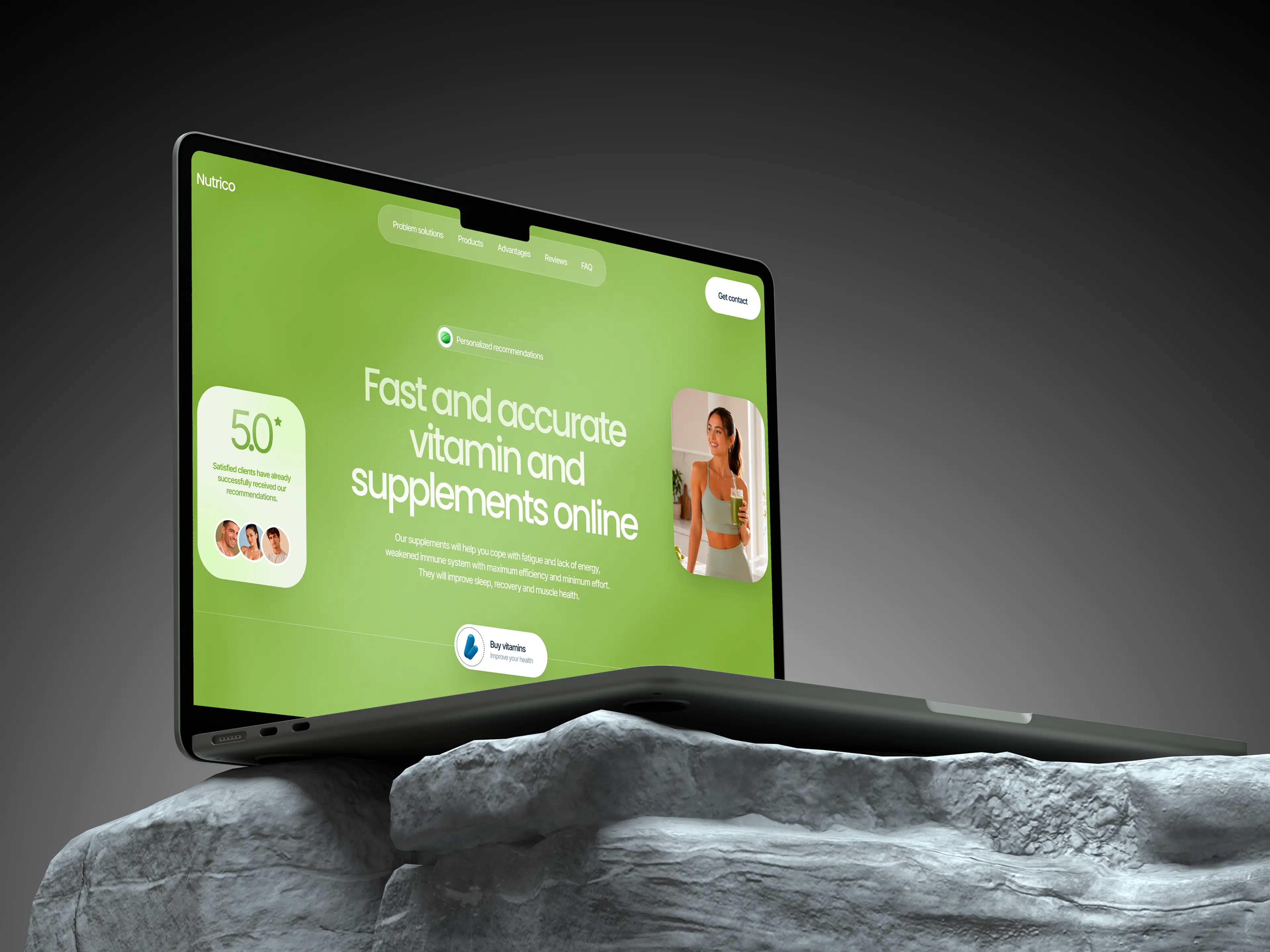 Angled laptop displaying a green vitamin supplement website, perched on a rugged gray rock against a dark background; modern, polished tone.