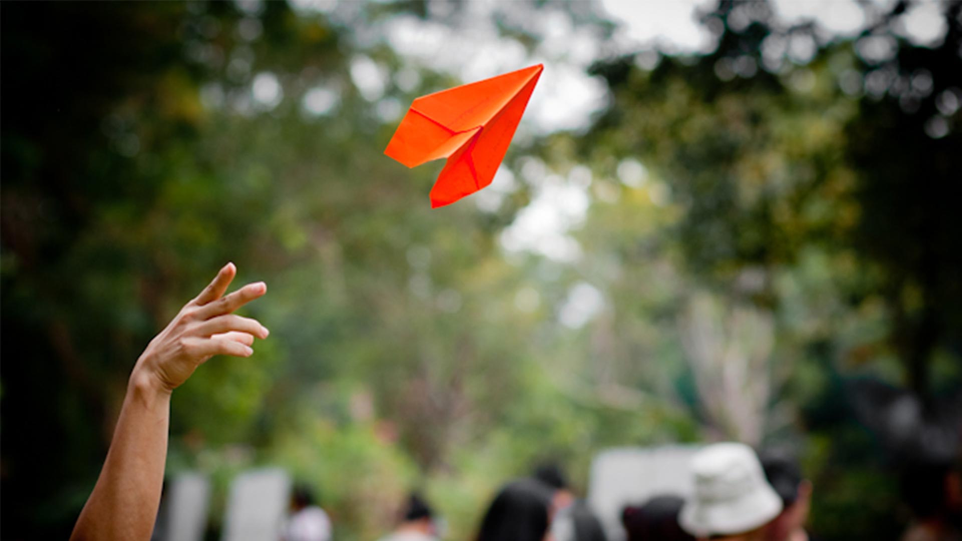 Orange paper plane in flight, from the Greenpeace innovation project
