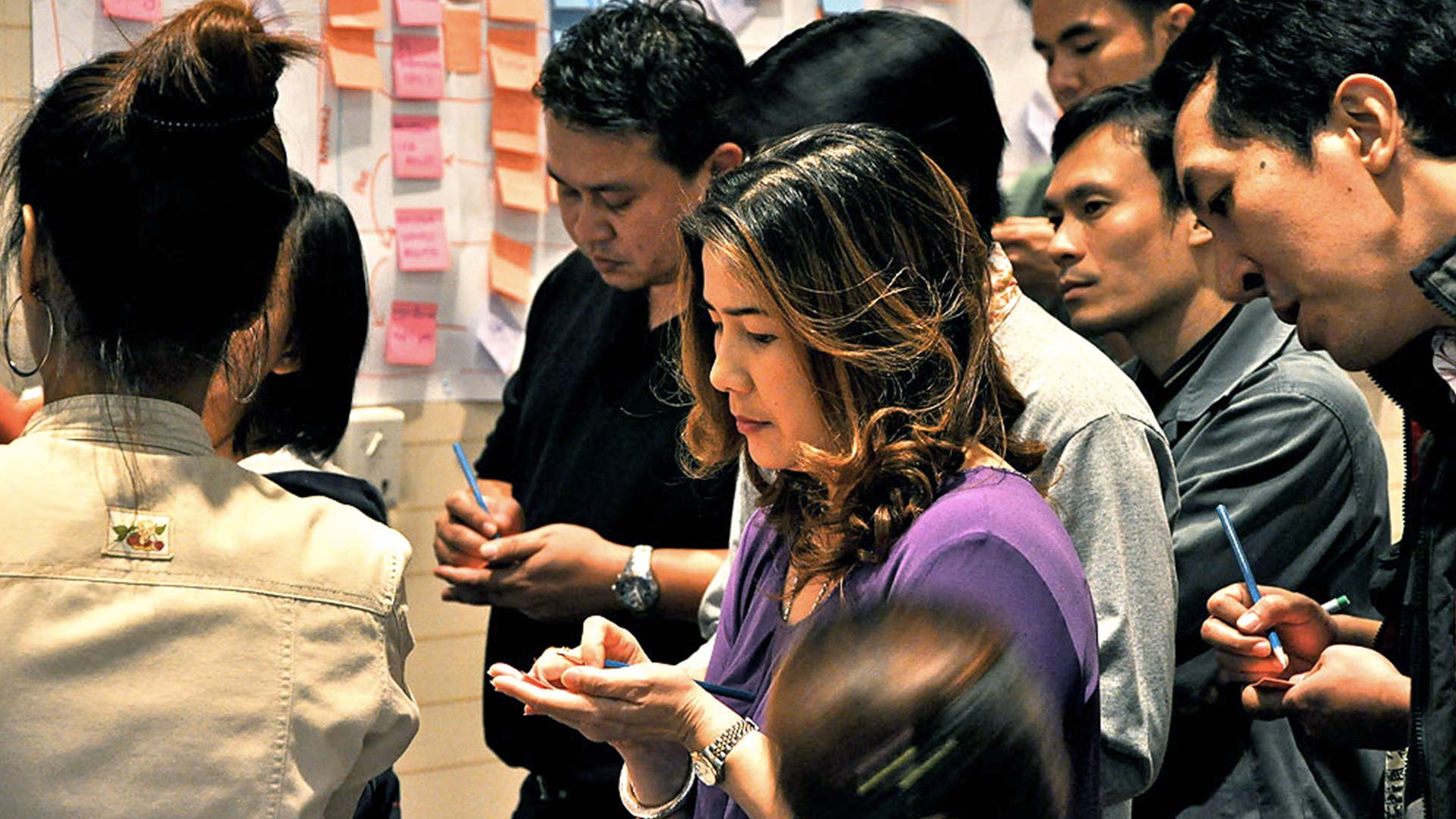 Workshop participants reviewing materials during the Mattel project