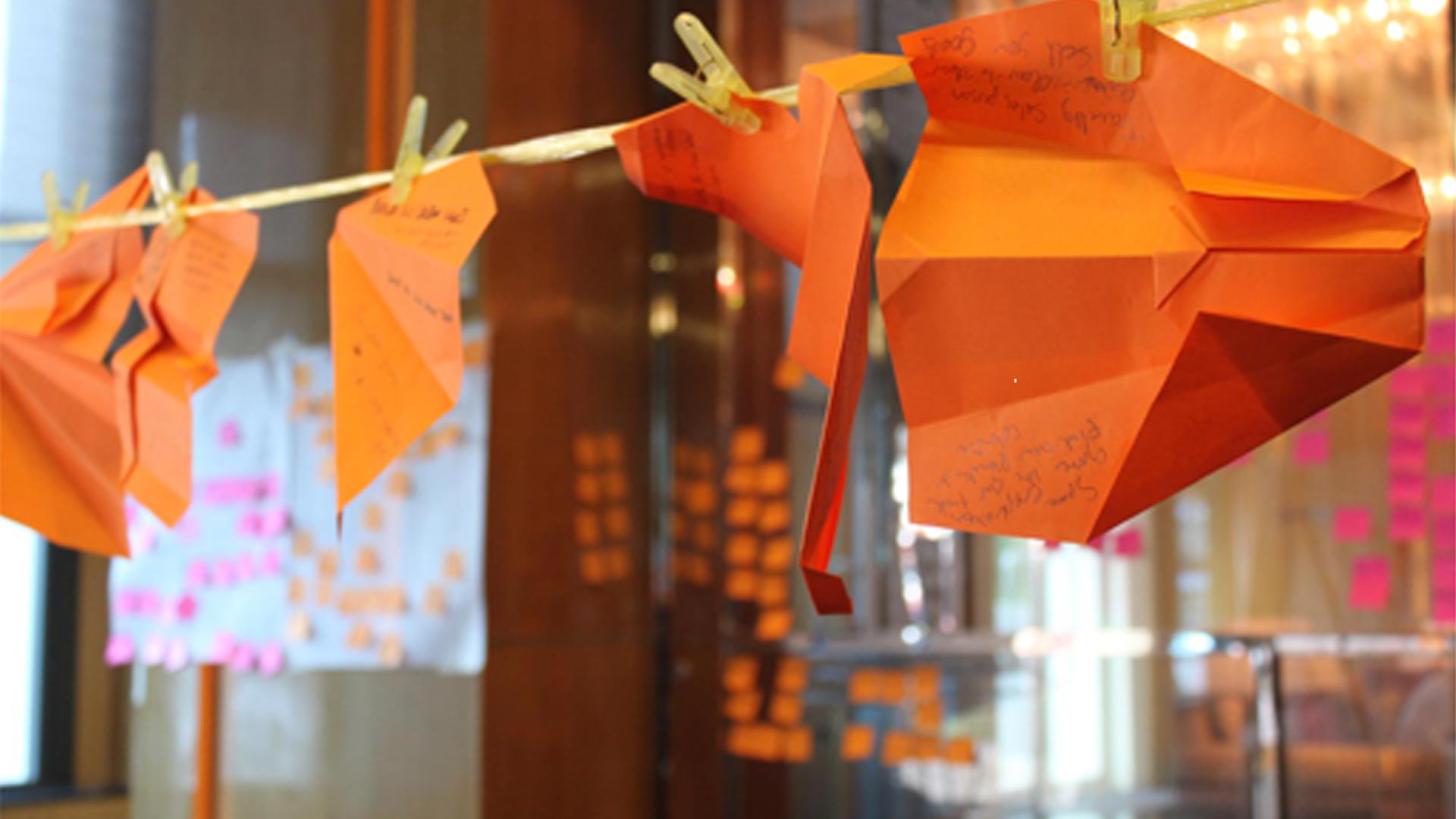 Orange paper decorations at the BASF and Lion innovation workshop